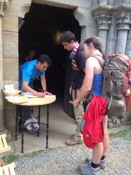 Katie and Tyler getting a stamp for the compostela